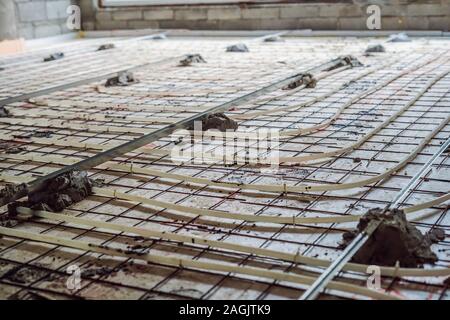 Pipe fitter mounted underfloor heating. Heating system and underfloor heating Stock Photo