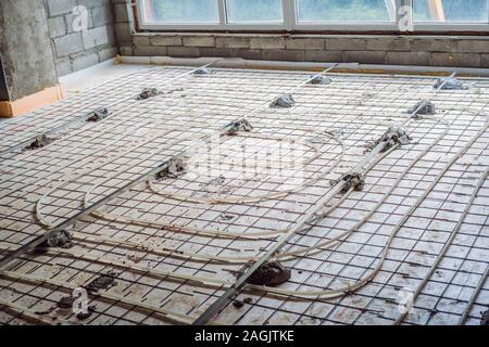 Pipe fitter mounted underfloor heating. Heating system and underfloor heating Stock Photo