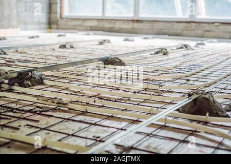 Pipe fitter mounted underfloor heating. Heating system and underfloor heating Stock Photo