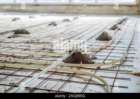 Pipe fitter mounted underfloor heating. Heating system and underfloor heating Stock Photo