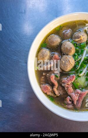 Typical Pho bowl served at Vietnamese street food vendor Stock Photo