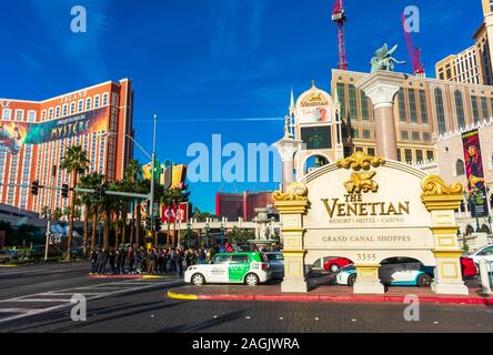 People and cars wait to cross street near The Venitian resort, hotel, casino - Las Vegas, Nevada, USA - December, 2019 Stock Photo