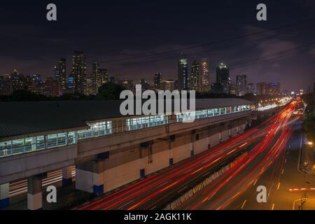 Manila, Philippines - September 1, 2017: Night landscape of EDSA road and Makati, panorama Stock Photo