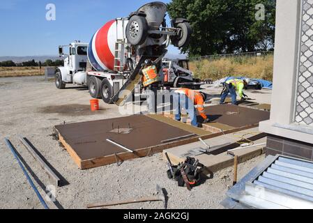 Construction workers laying a mock concrete slab to test. Stock Photo