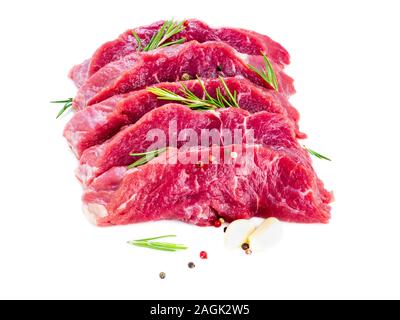Raw meat, beef steak with seasoning on white background, side view. Stock Photo