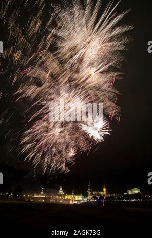 Colorful fireworks illuminating the old part of the town, seen from the meadows along the river Elbe Stock Photo