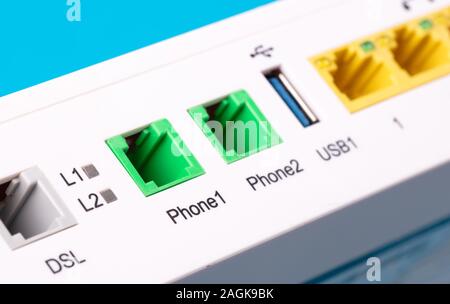 Desktop Home ADSL modem on a blue background back view, selective focus Stock Photo