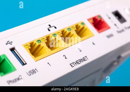 Desktop Home ADSL modem on a blue background back view, selective focus Stock Photo