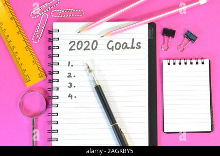 2020 goals written on a diary on a pink background Stock Photo