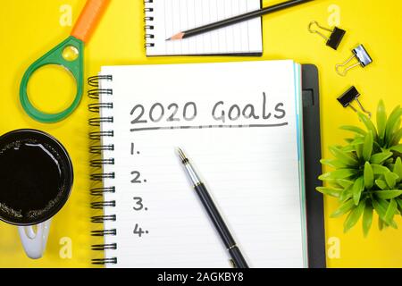 2020 goals written on a book with yellow background Stock Photo