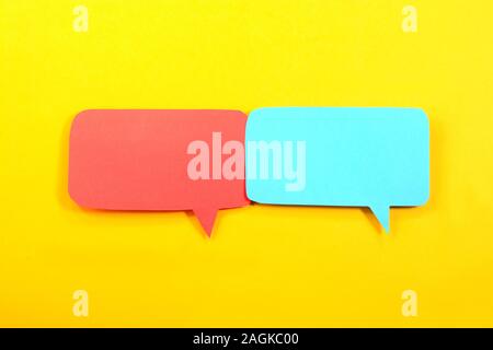 Multicolored speech bubbles on yellow background Stock Photo