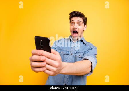 Photo of stylish trendy brunet cheerful man crazy about having noticed interested thing photographing it isolated over vivid color background Stock Photo