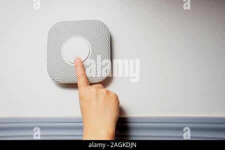 Smoke, fire and Carbon Monoxide Alarm being test with a soft shadow Stock Photo
