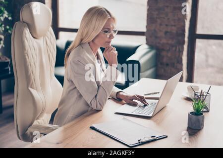 Photo of professional qualified executive assistant wearing glasses spectacles searching for new information about development and unification Stock Photo