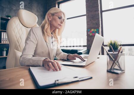 Low below angle view photo of focused pensive thinking entrepreneur heading team of programmers working on new grand project comparing document Stock Photo