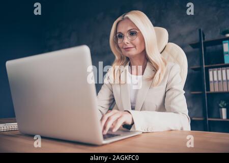 Low below angle view photo of creative manager of large international company working with computer connecting to her workers by using internet Stock Photo