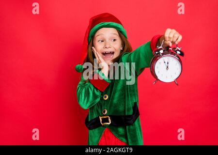 Close-up portrait of her she nice attractive cheerful cheery surprised shocked glad funny pre-teen elf holding in hands clock fairy miracle night Stock Photo