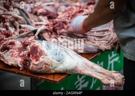 Xian, China -  August 2019 :  Gross lamb and cow carcass meat and bones with blood on a table of the street food vendors in the Muslim quarter of Xian Stock Photo