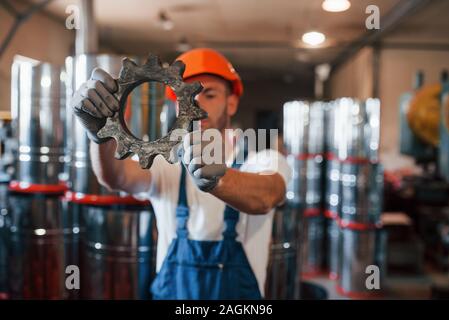 Blurred background. Man in uniform works on the production. Industrial modern technology Stock Photo