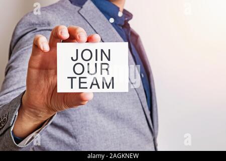Join our team. Close up of businessman showing card. Stock Photo