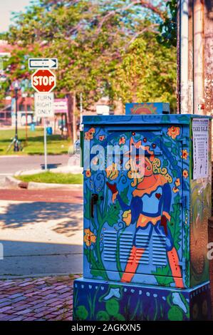 A yard sale sign affixed on a mural adorned outdoor utility/electrical box in Ann Arbor, Michigan. Painted utility box. Decorative utility box.