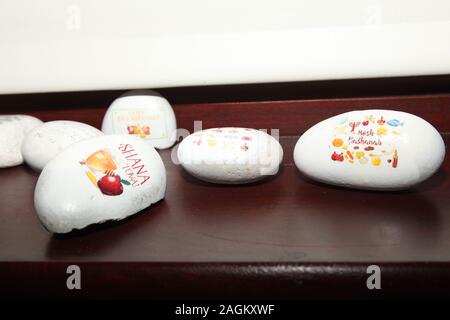 Painted stones with Jewish messages painted on pebbles as part of the Rockfun rock painting activity Stock Photo