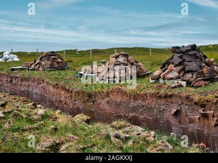 Peat drying next to the peat bank it was cut from, Isle of Harris, Outer Hebrides, Scotland Stock Photo