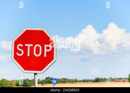 Stop sign against blue sky Stock Photo