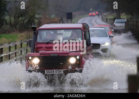 Lacock, Wiltshire, UK. 20th December 2019. The River Avon in Lacock has burst its banks and flooded the road out of the village. The road is passable with caution. Credit: Mr Standfast/Alamy Live News Stock Photo