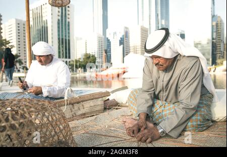 Abu Dhabi, 14th Deceber 2019: fisherman weaving a basket for catching grabs Stock Photo