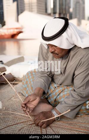 Abu Dhabi, 14th Deceber 2019: fisherman weaving a basket for catching grabs Stock Photo