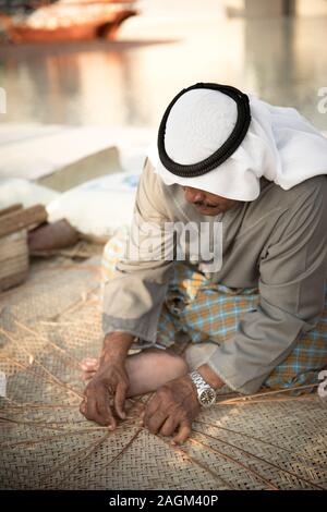 Abu Dhabi, 14th Deceber 2019: fisherman weaving a basket for catching grabs Stock Photo