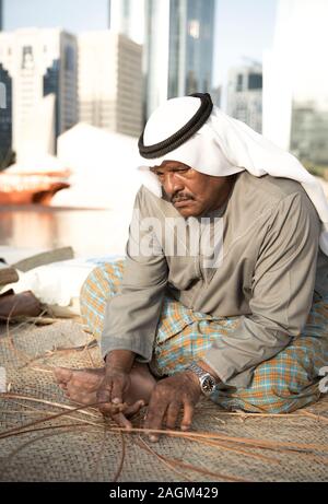 Abu Dhabi, 14th Deceber 2019: fisherman weaving a basket for catching grabs Stock Photo