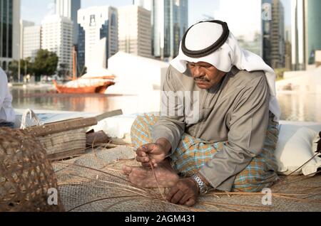 Abu Dhabi, 14th Deceber 2019: fisherman weaving a basket for catching grabs Stock Photo