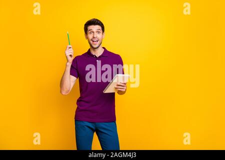 Portrait of his he nice attractive genius focused cheerful cheery glad guy creating making notes cool idea isolated over bright vivid shine vibrant Stock Photo