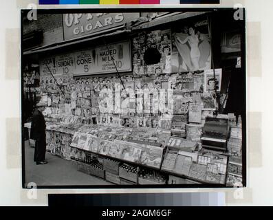 Newstand next to State Coffee Shoppe, large display of magazines, ads for sundaes, Coca-Cola above, boxes of sodas below, man at left Citation/Reference: CNY# 15 Code: III.1.f.; Newsstand, 32nd Street and Third Avenue, Manhattan. Stock Photo