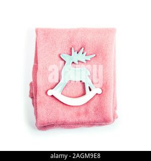 Light blue deer with pink knitted sweater on the white isolated background. Stock Photo