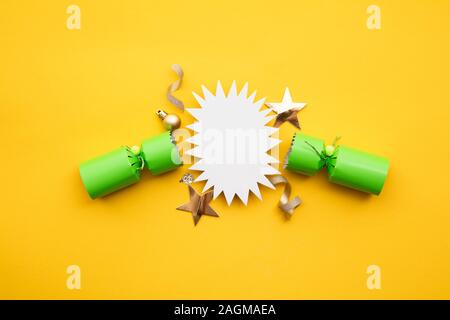 Popped Christmas crackers on a yellow background Stock Photo