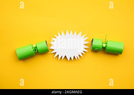 Popped Christmas crackers on a yellow background Stock Photo