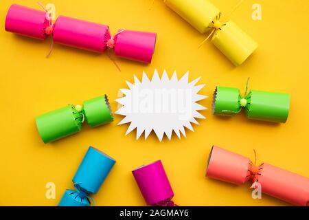 Popped Christmas crackers on a yellow background Stock Photo