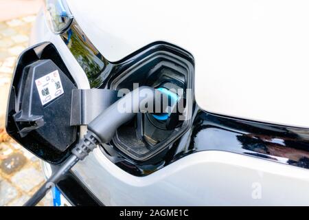 Charging modern electric car on the street Stock Photo