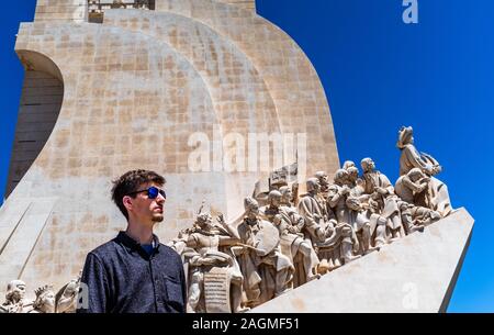 Tourist in sunglasses in front of Monument to the Discoveries on a sunny day. Stock Photo