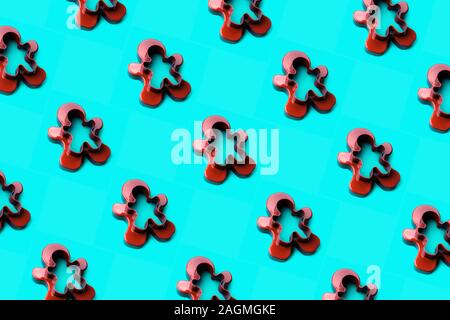 A form for cutting a gingerbread man standing on a blue emerald background Stock Photo