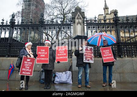 London, UK. 20 December, 2019. Brexit supporters holding placards gather outside Parliament as the Brexit Withdrawal Agreement Bill is resubmitted for debate and a vote inside the House of Commons. Credit: Mark Kerrison/Alamy Live News Stock Photo