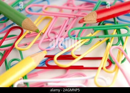 Close-up of multi-colored paper clips on a white background. Stock Photo