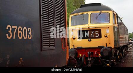 Class 48 British Rail Diesel Engine, in green and yellow livery - 0000 , IM45, Brush Type 4, in goods sidings yard with 37603, England, UK Stock Photo