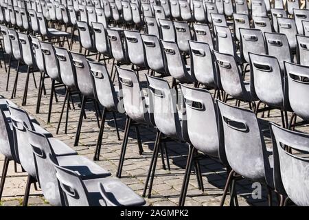 Rows of grey empty chairs Stock Photo