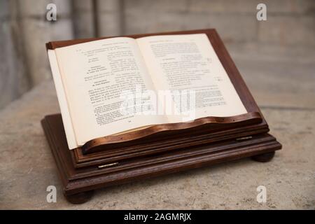 Old book of mass open on an altar with a passage of the bible in French written on it. Stock Photo