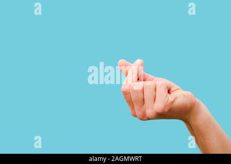 cropped view of female hand snapping fingers isolated on blue Stock Photo