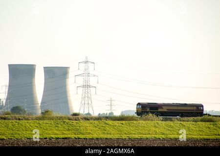 A freight train travels across the British countryside taking goods from A to B. Stock Photo